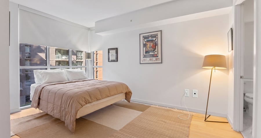 Featuring a comfortable queen-size bed and expansive windows with custom blackout shades for a perfect night's sleep.
