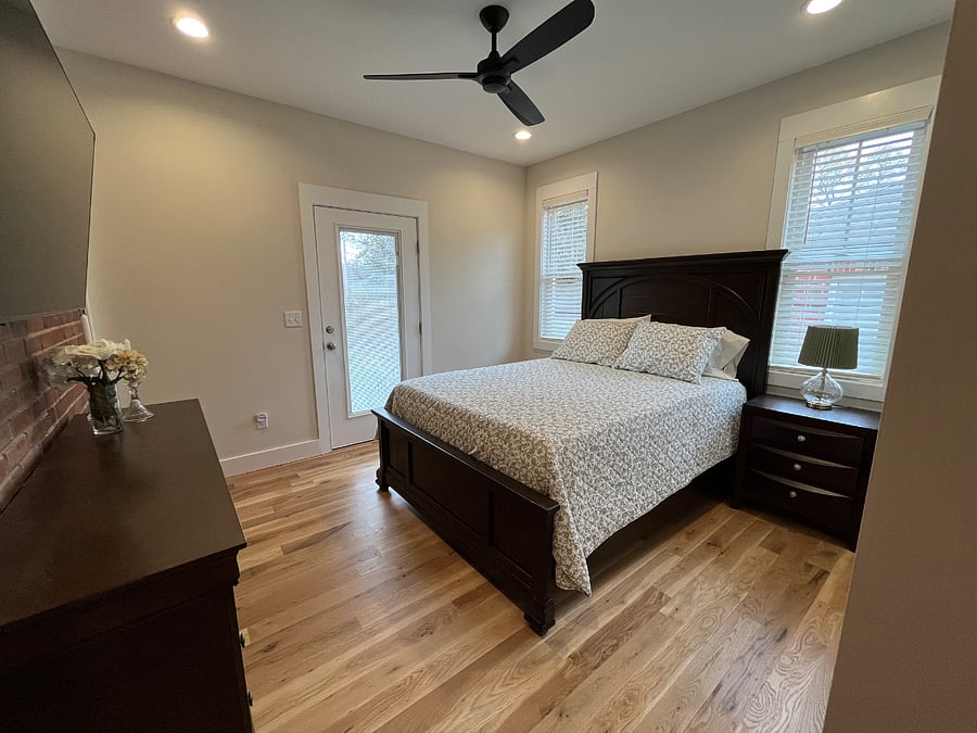 Bedroom with 55 inch smart TV and blackout curtains