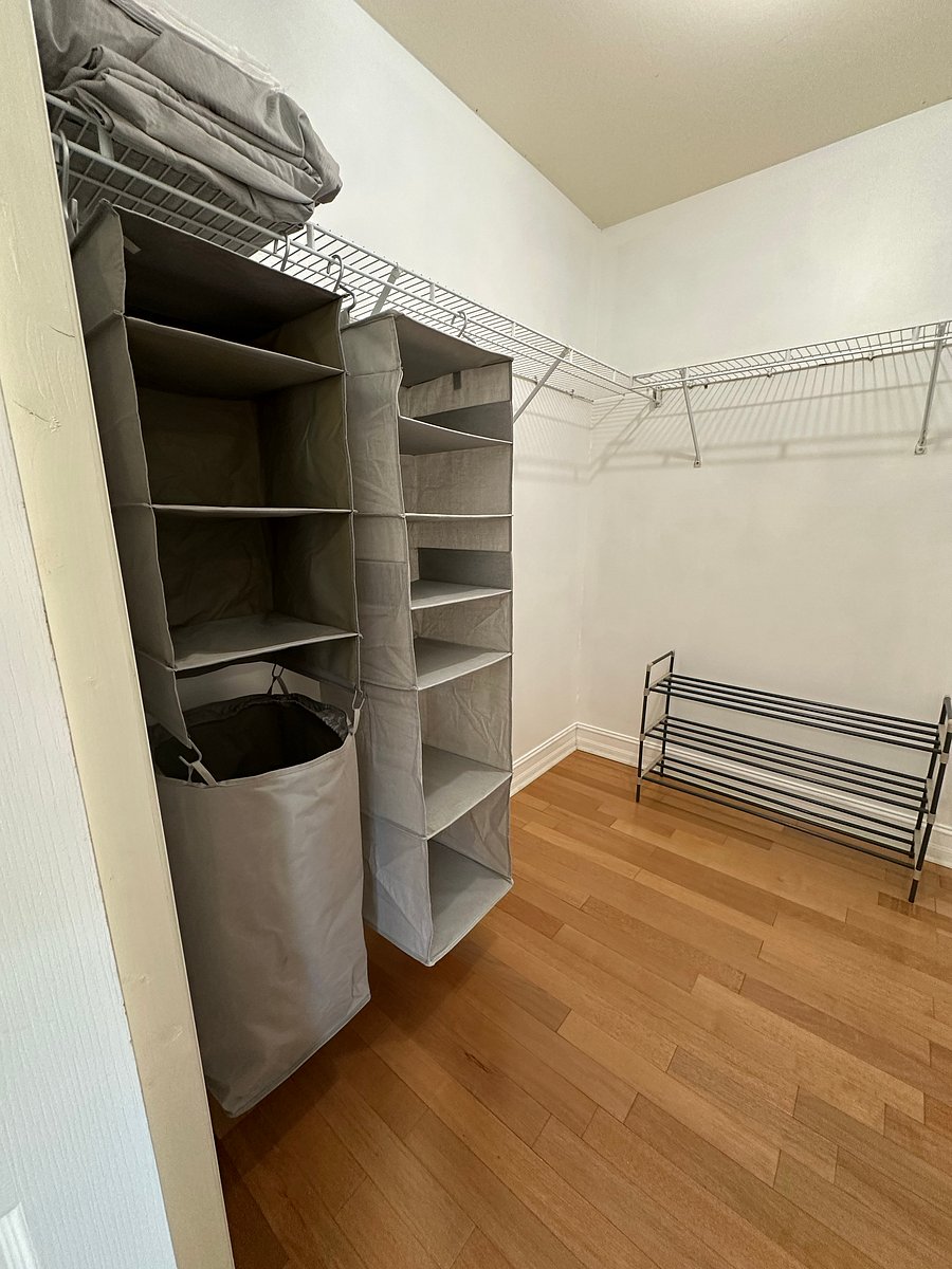 Master Closet with Storage shelves, shoe rack, laundry basket.