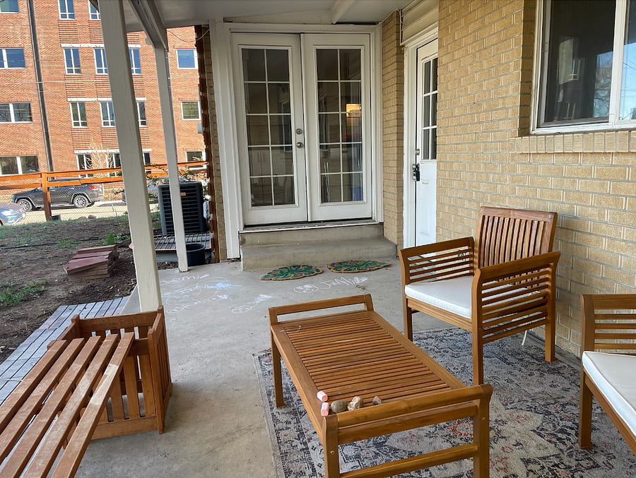 Back patio facing the private parking pad. The french door opens to a common kitchen, the door to the private basement is right by the fridge.