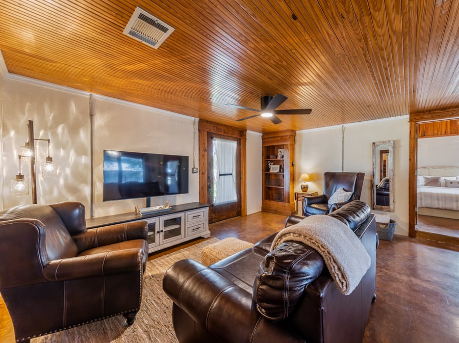 Leather seating in living room with 50" smart TV.