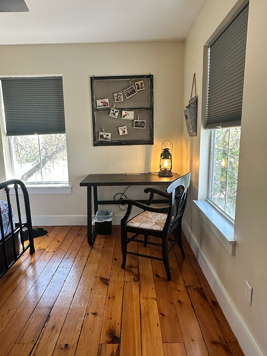 The third bedroom has a desk and chair for a dedicated workspace, with lots of natural light.