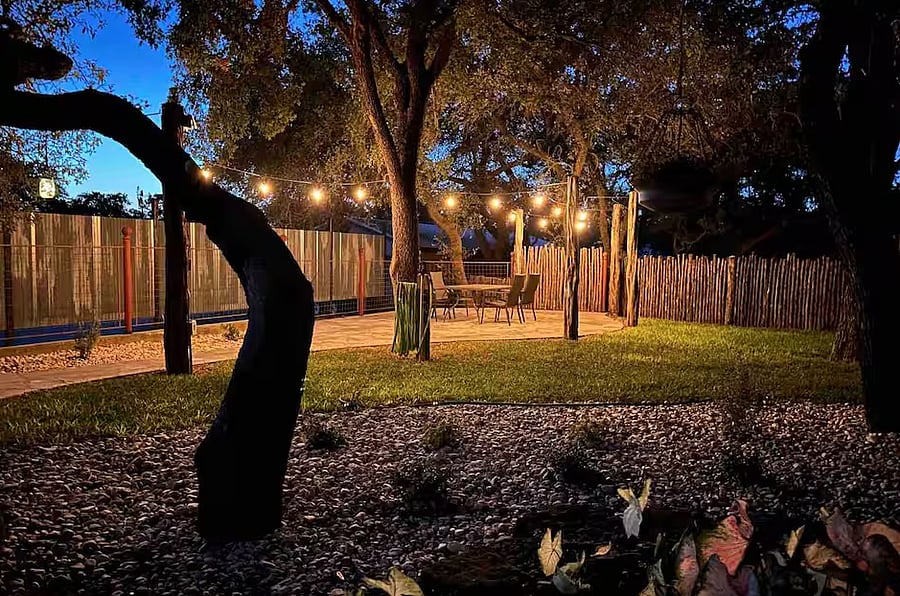 The back patio has string lights, which are perfect for sitting under in the evenings. There is also a new gas BBQ grill here.
