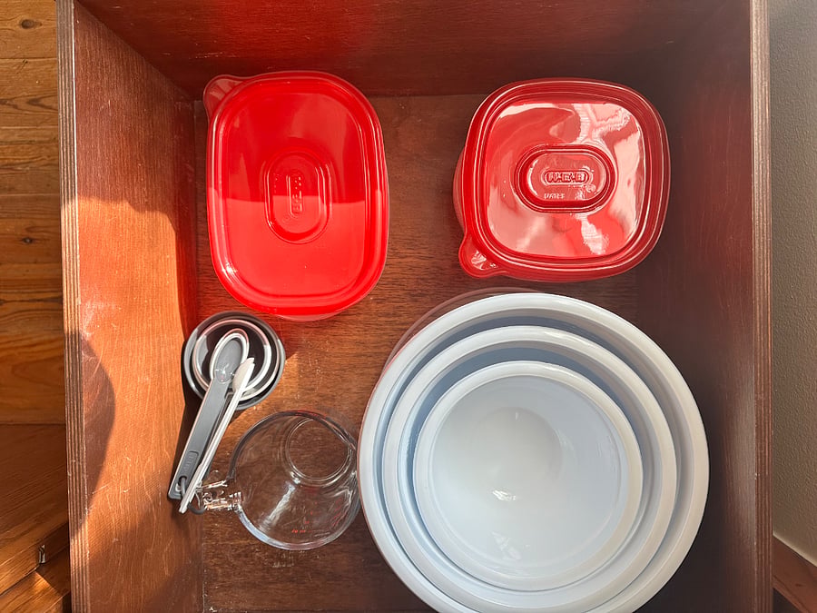 Food storage containers, mixing bowls, measuring cups and spoons.