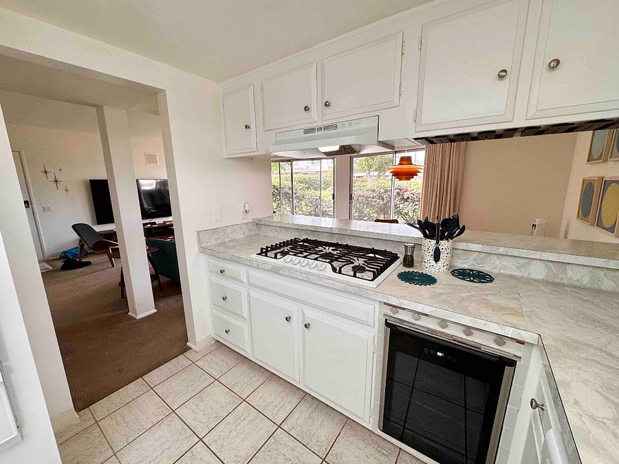 Kitchen open to dining and living room featuring beverage fridge