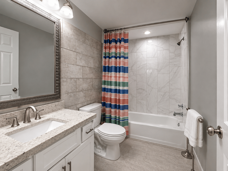 Clean full bathroom with a tub and shower - freshen up and feel at home during your stay.