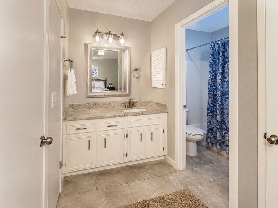 Second full bathroom with a large vanity and mirror - convenient extra space for busy mornings.