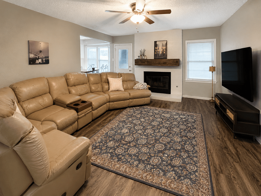 Spacious living room with a large comfortable sectional and TV - unwind and relax after a long day on assignment.