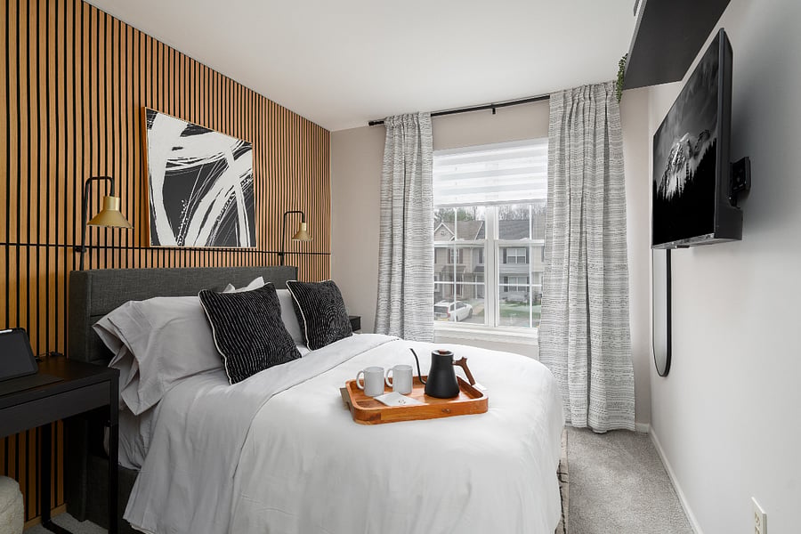 Modern, design-forward suite featuring a statement wood accent wall, premium bedding, and curated touches for a boutique hotel feel. Enjoy a serene, light-filled atmosphere designed for elevated comfort