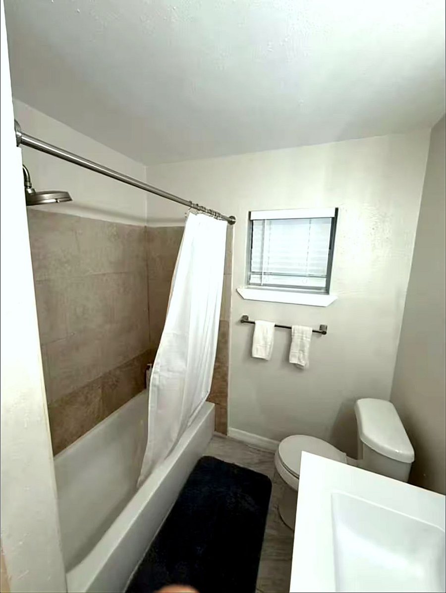Clean, well-maintained bathroom with tub and shower