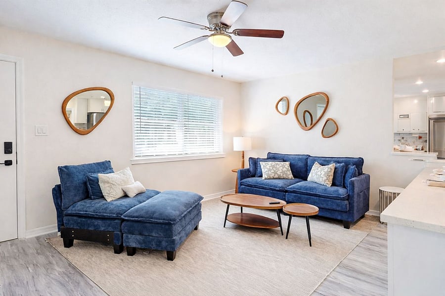 Comfortable, stylish living space with ceiling fan, natural light, and modern dcor