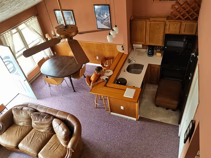 Dining area with breakfast bar and small but full kitchen with full size dishwasher, oven, and refrigerator. There is a good-sized pantry closet and cabinets, and all the dishes, pots, and pans you could need.
