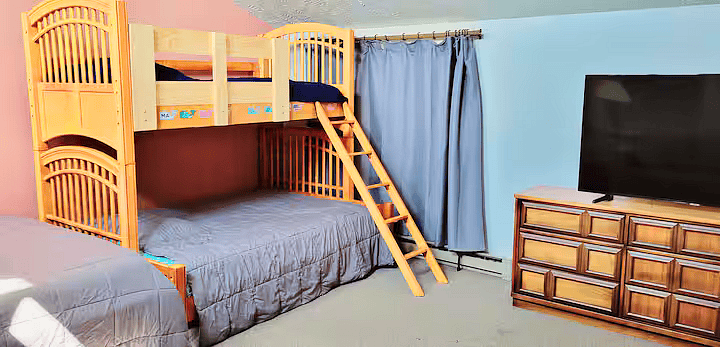Upstairs loft bedroom has bonus living space. One queen bed and a twin over full bunk bed. Smart TV, small couch and toys (Magnatiles and Thomas the Train set).