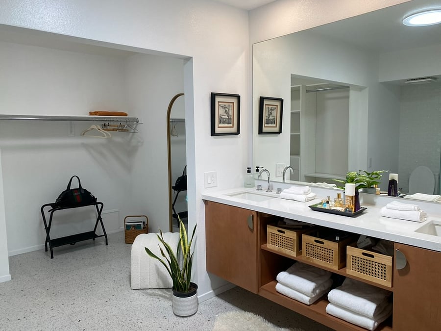 Primary Bathroom ensuite with walk in closet and build in shelves, drawers
