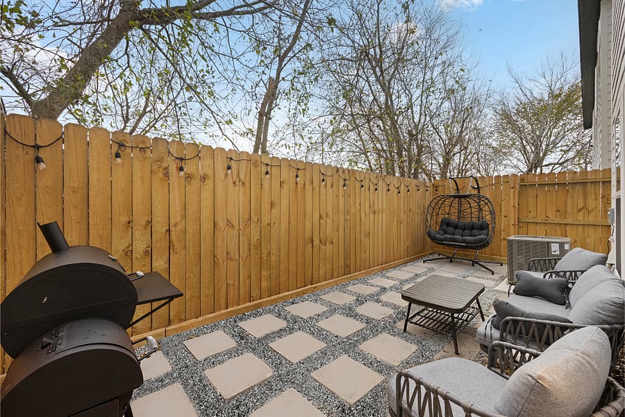 Private backyard patio with seating and outdoor cooking