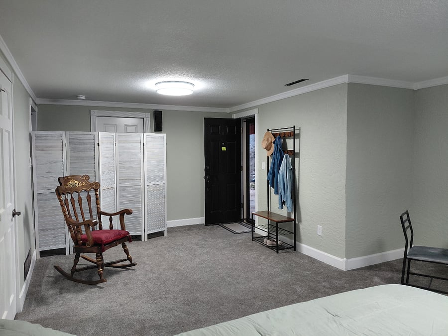 private exterior entry door, coat rack, rocker, screened off garage door and stairs to main floor