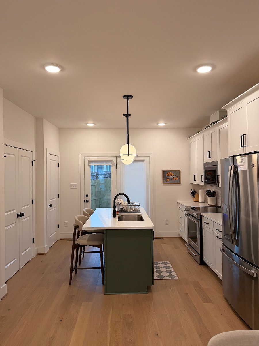 Clean and organized kitchen with very large pantry, full size fridge, and closet space for cleaning materials 