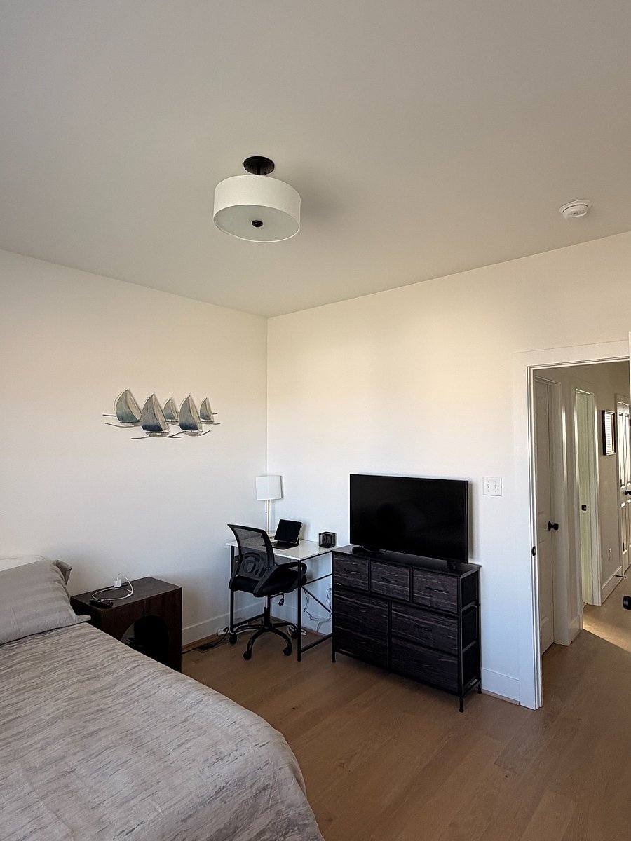 Room 2 - Available at $1,000/month
Includes NEW BLACK OUT CURTAINS, smart TV, bedside table, desk and chair, large closet, and dresser