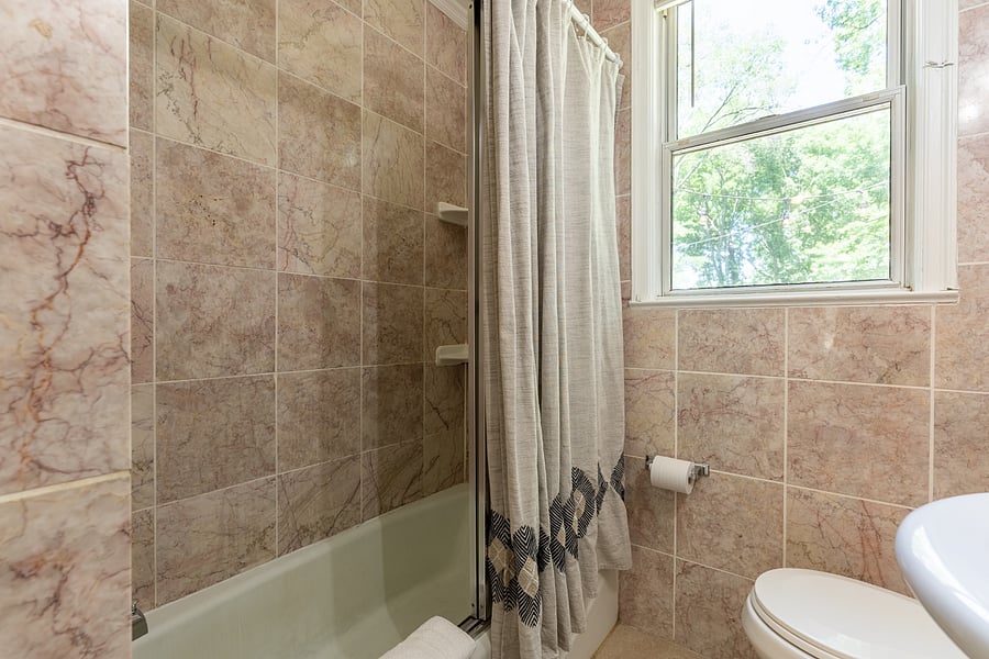 Marble tile and tub/shower combo.