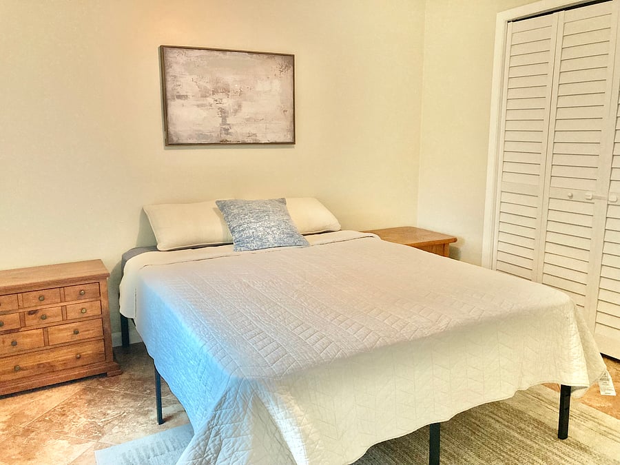 Bedroom 3 has a queen size bed and a closet. It has a window that looks out over the backyard. The bedroom is located on the back side of the house next to the dining room.