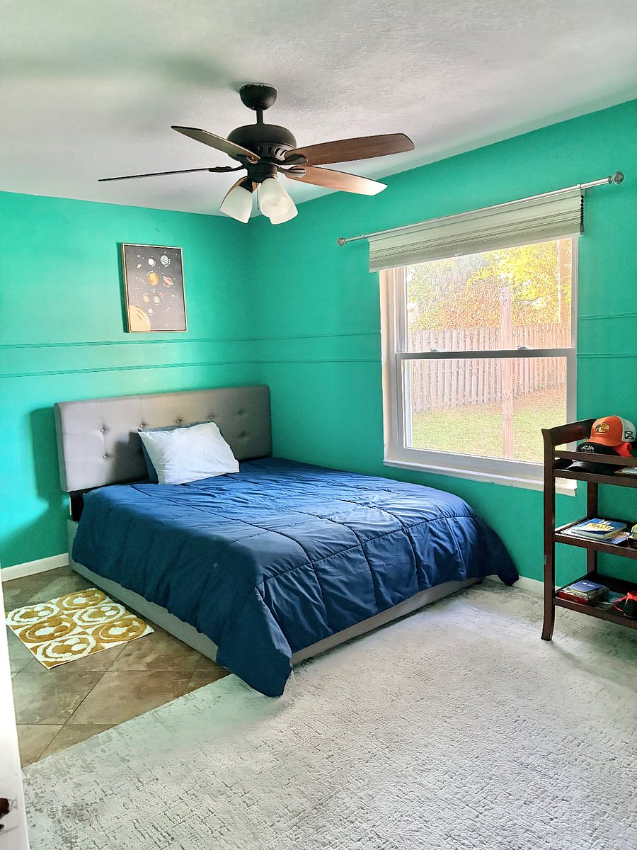 Bedroom 2 has a queen size bed with a twin trundle bed below. The window has a beautiful view of the backyard.