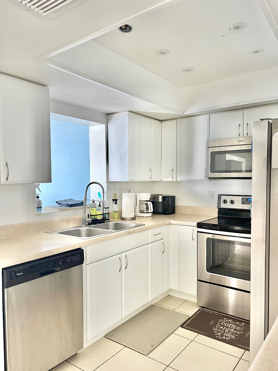 Kitchen sink over looks the dining room and glass slider doors to the backyard.