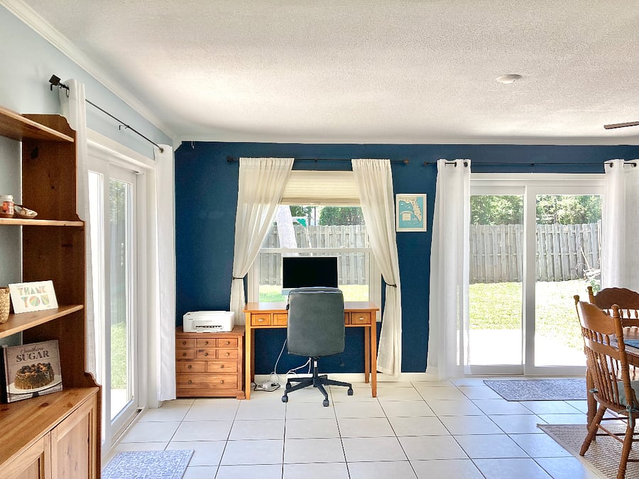 Desk and office chair with lots of natural lighting.