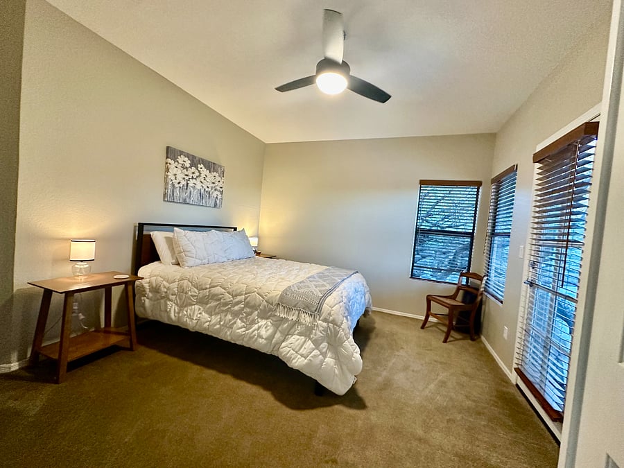 Primary bedroom, door leading from bedroom to the screened in porch. 