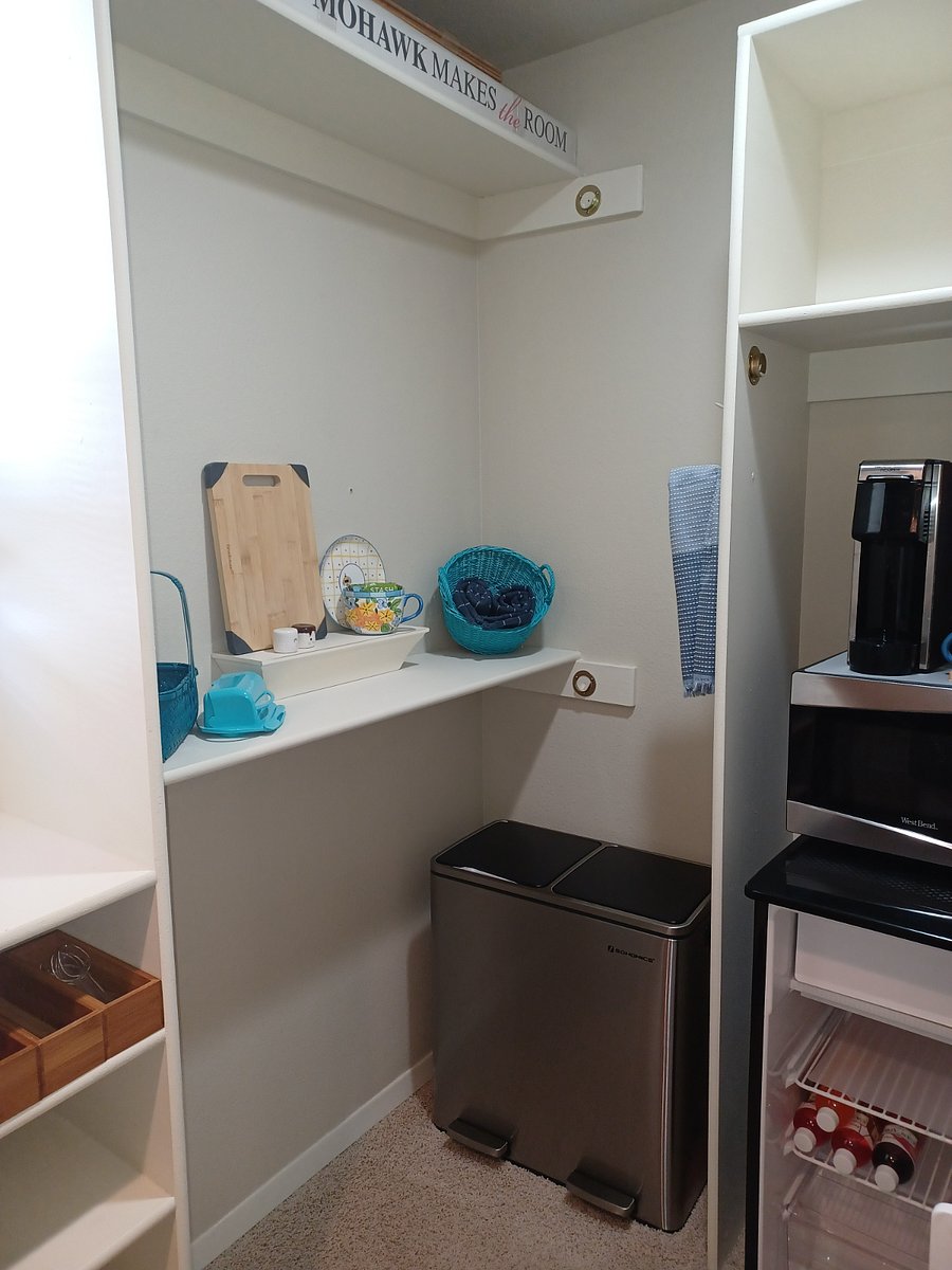 Kitchen towels, tea, cup, cutting board, knives, butter holder