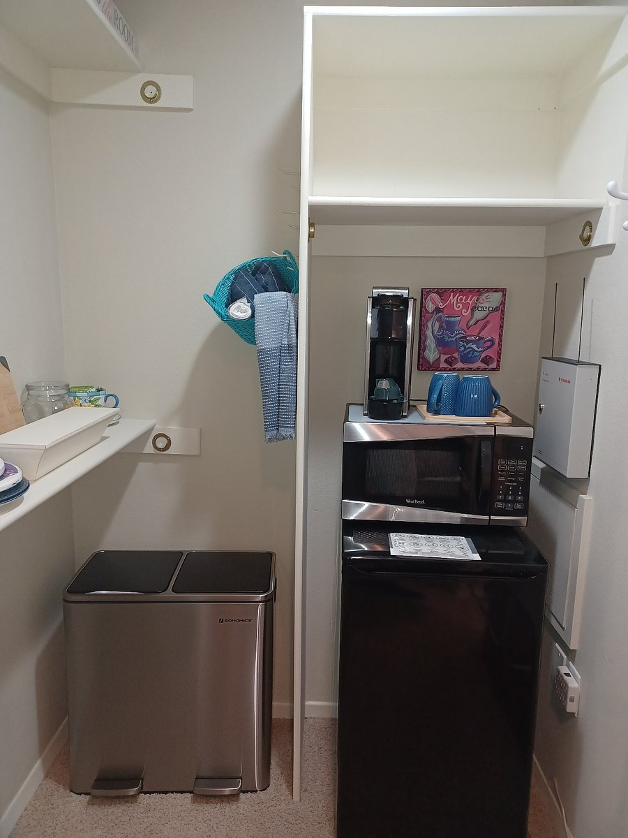 Amenities include a microwave, coffee maker, small refrigerator/freezer, plates, coffee mugs, water glasses, and wine glasses.