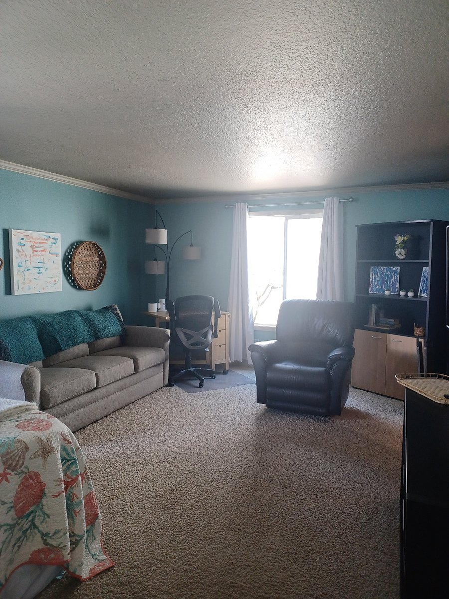 Inside of room, showing very comfortable, La-Z-Boy hideaway bed/couch and recliner. In addition, table/desk & chair for work.