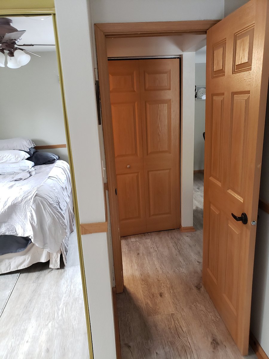 View from the bedroom out towards the hallway. Linen closet with bifold door is pictured here.