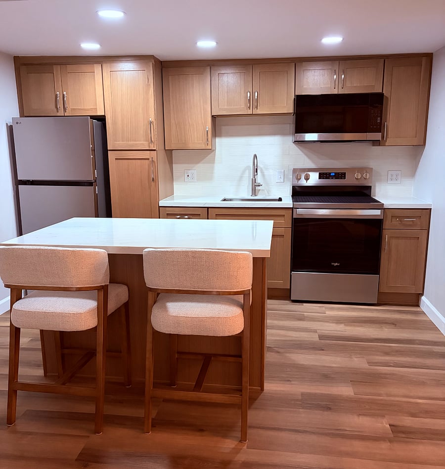 Kitchen with Island and ample storage. Appliance include Keurig or Nespresso coffee maker, Cangshan Knives, toaster, mixing bowls, utensils.