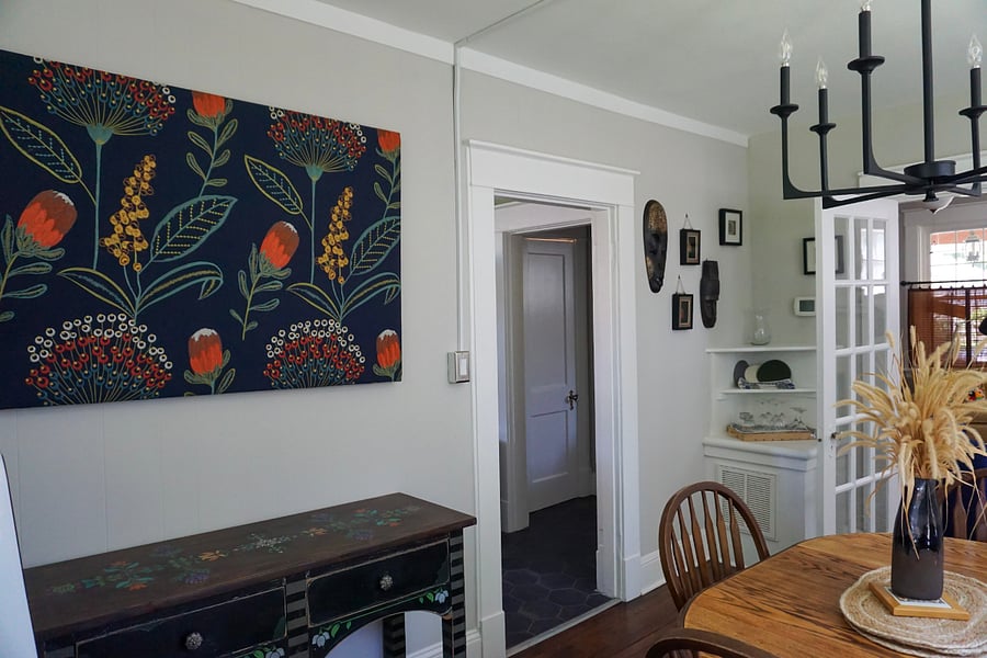 Dining room into the kitchen with a view of the basement door.
