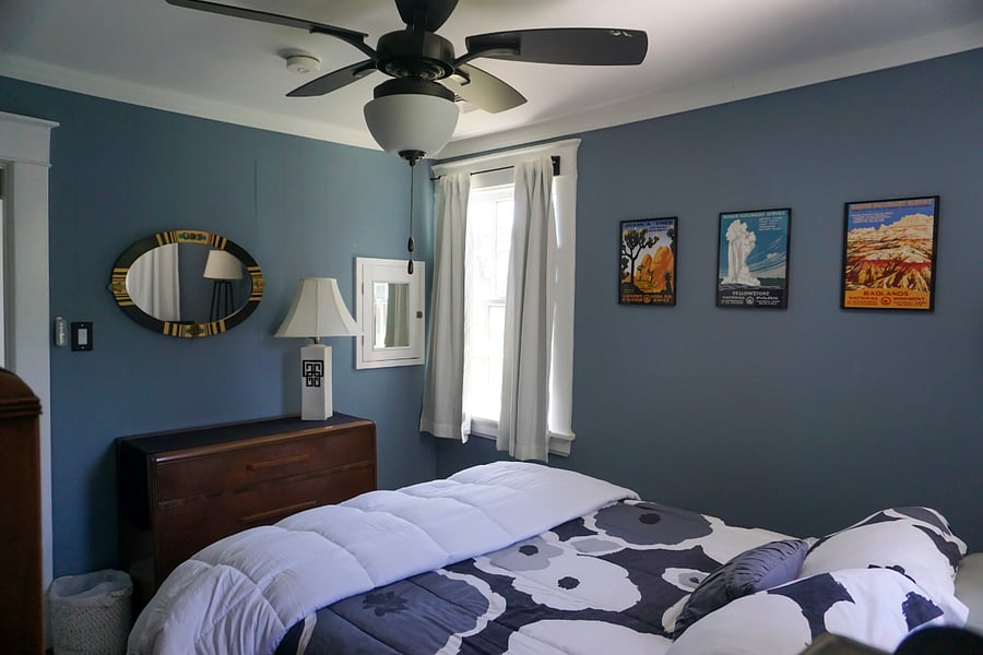 Upstairs corner bedroom: queen bed, large dresser. The small white mirror is the original medicine cabinet door and is now the water access panel for that bathroom.