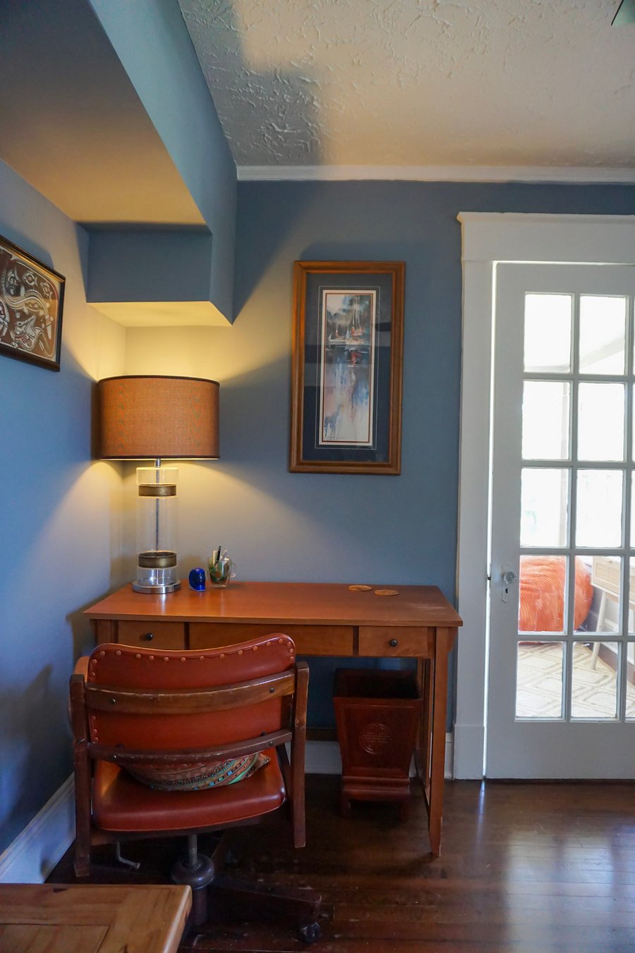 Upstairs living room: desk with 2 sets of outlets nearby. To the right of the glass door to the sun porch, is an extra closet for storage.