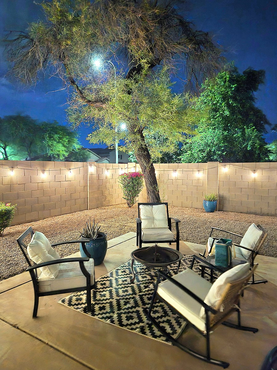 Backyard patio with updated seating, firepit, and large wooden block tower game.