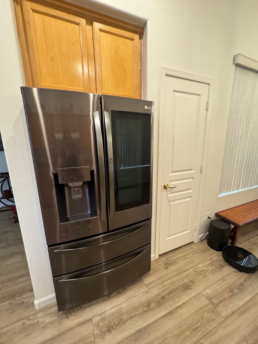 New large refrigerator with ice dispenser and filtered water.