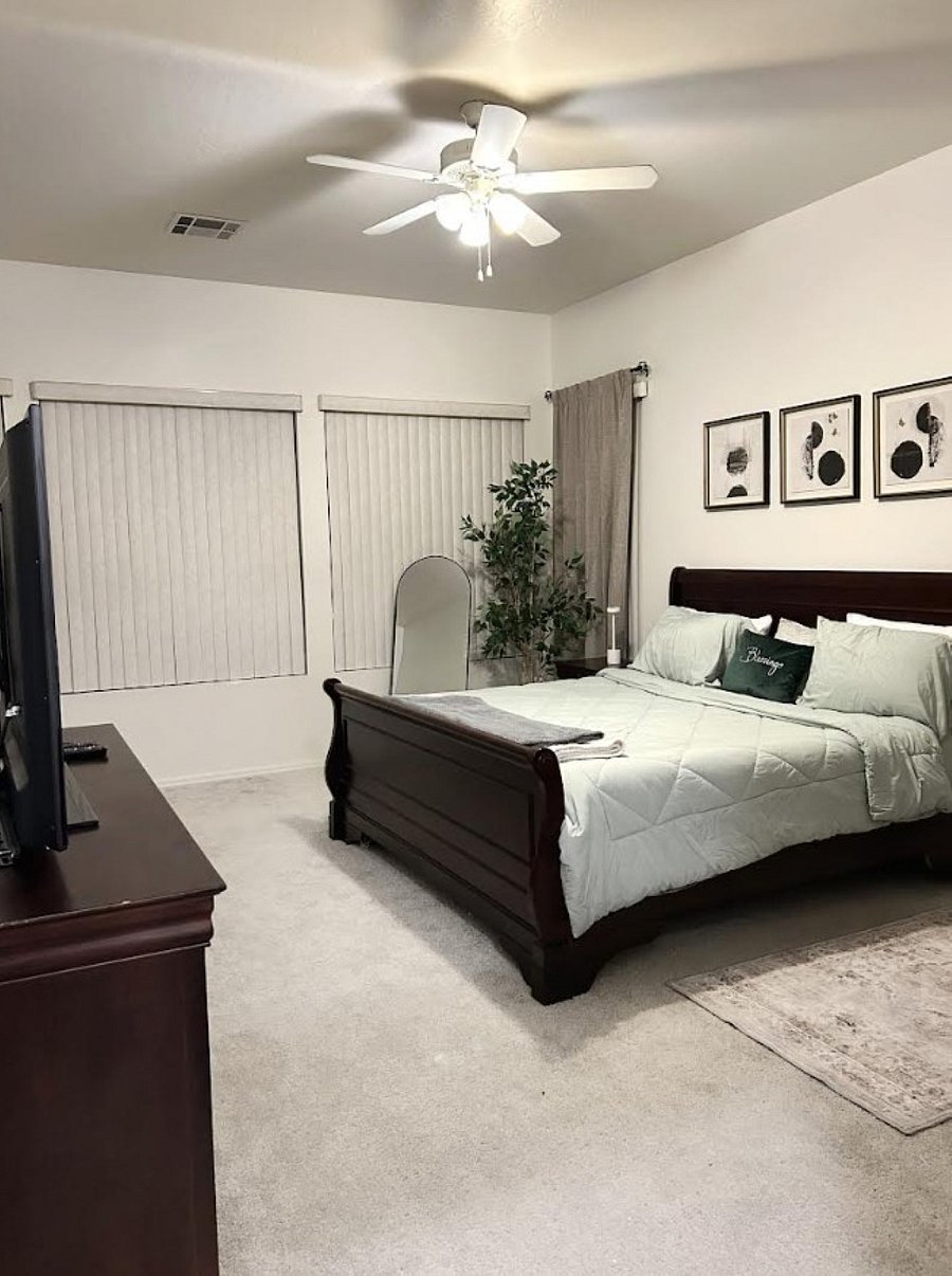 Primary bedroom with king size bed, TV, rocker/recliner, reading nook with futon for additional sleeping options.