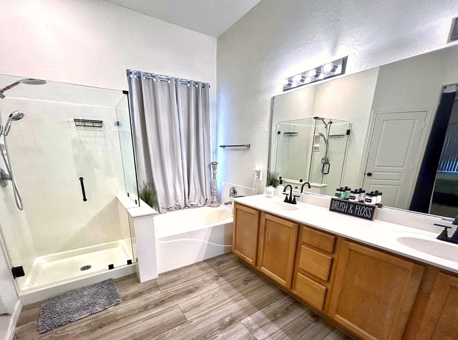 Primary bathroom with private toilet room, new shower glass, updated flooring, large tub for relaxing.
