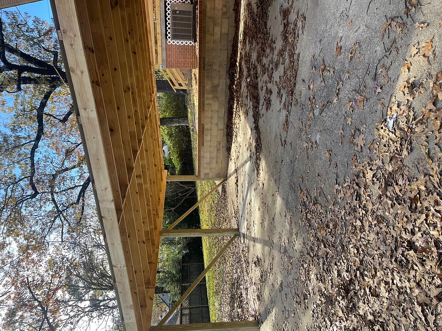 Covered Carport, enough space for two cars. Door to lower entrance is covered.