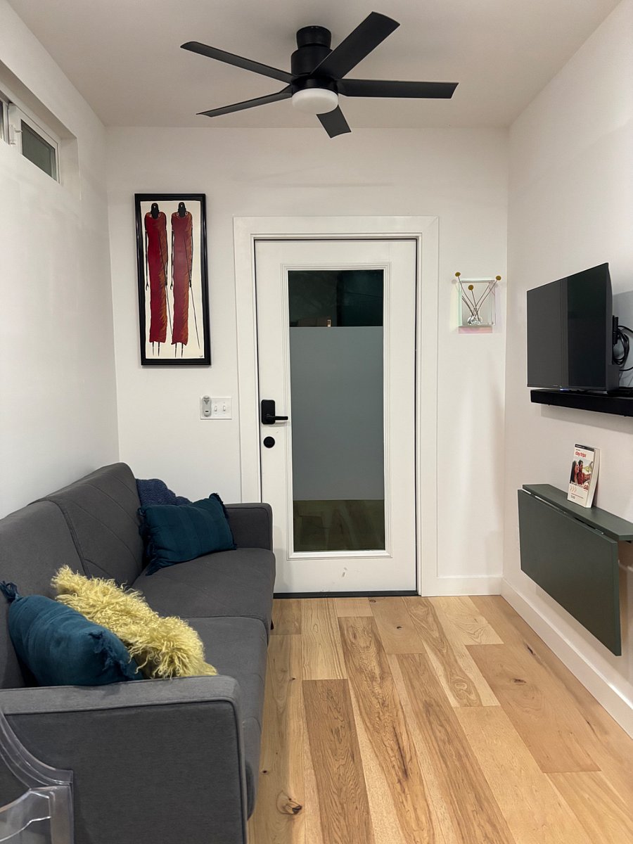 Front door and living room space featuring smart TV and a folding table for workspace or eating.