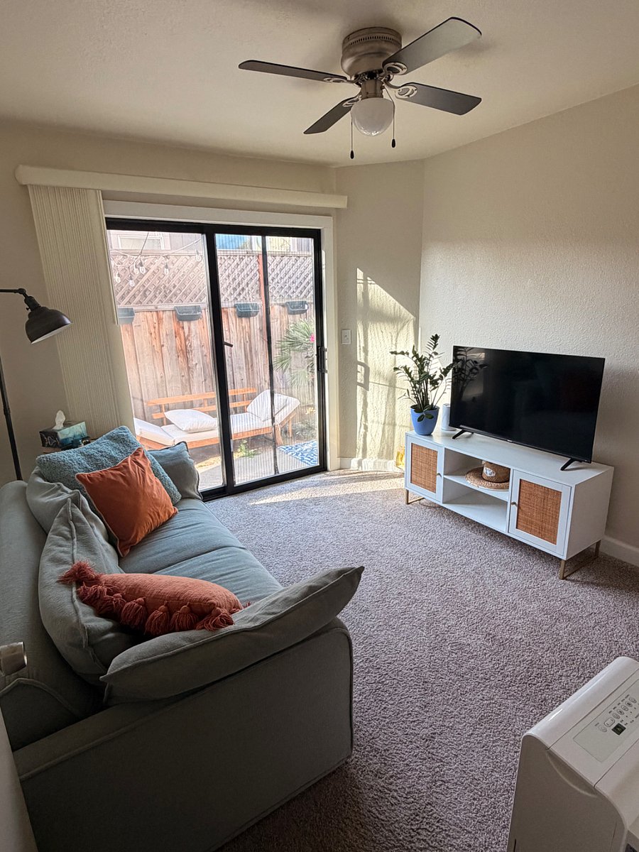 Office room with love seat and smart tv; access to back yard