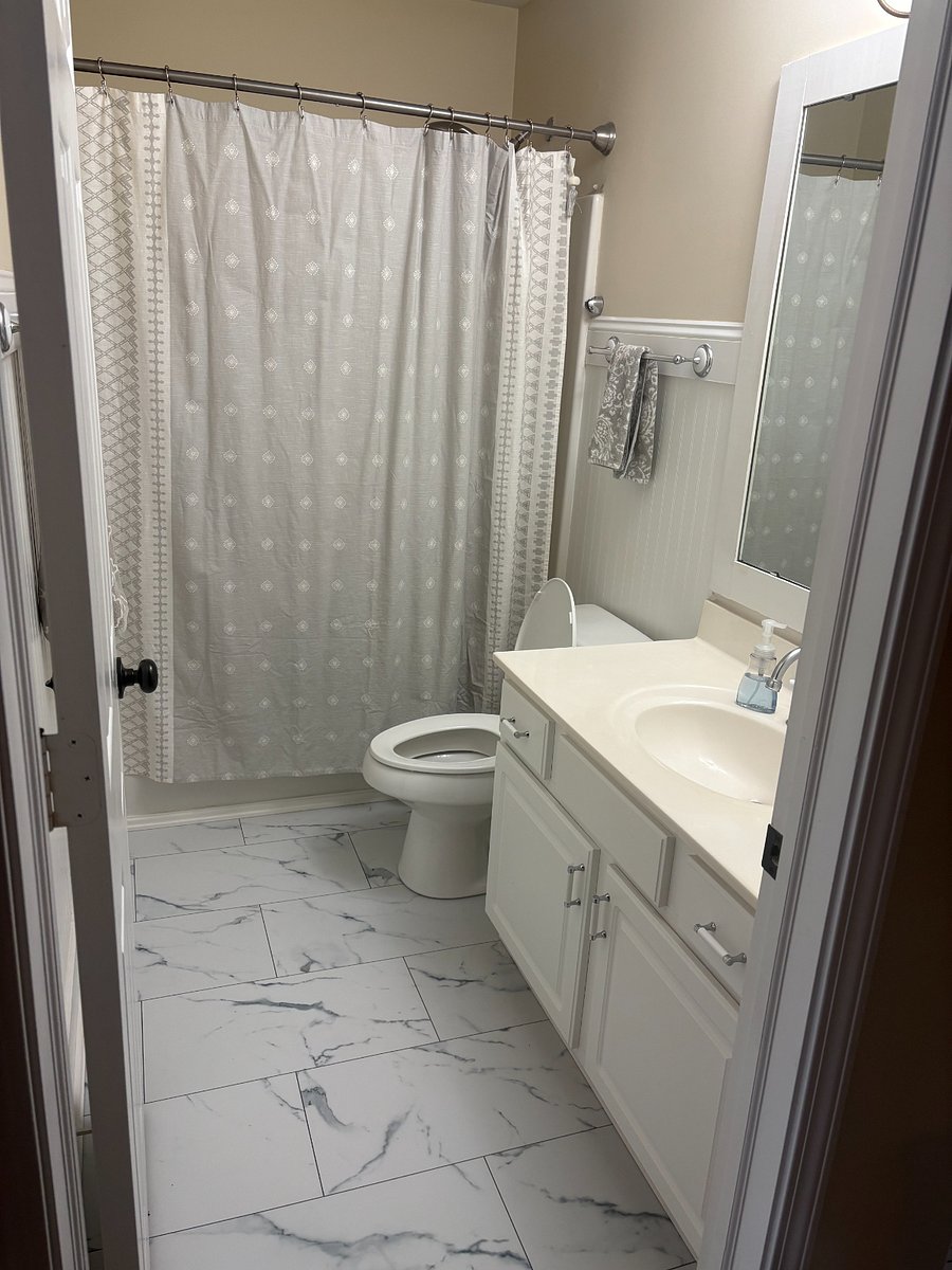 Your private bathroom, which includes a bath/shower combo with a removable handheld shower head.