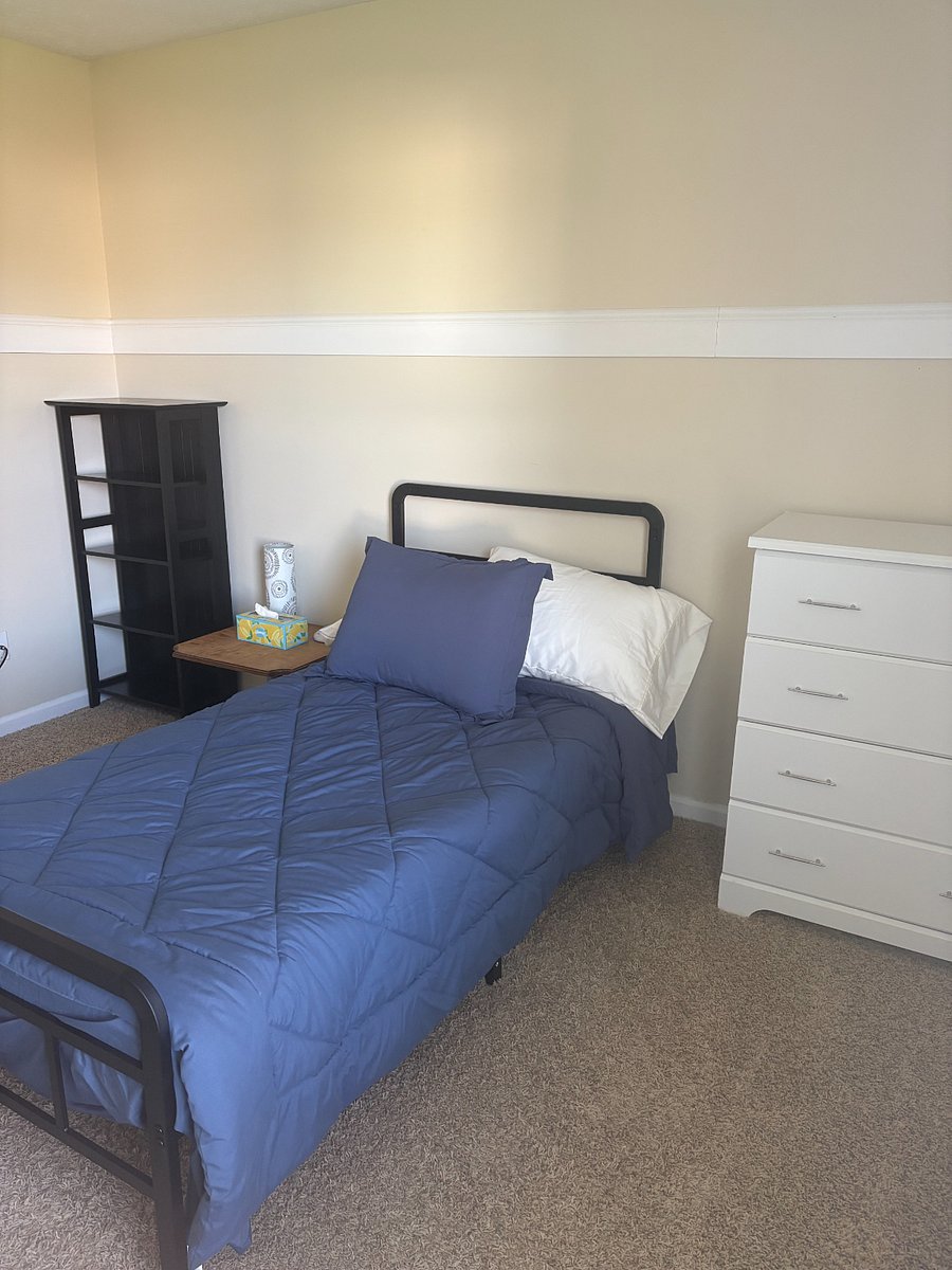 Bedroom includes twin bed, dresser, side table, and bookcase.