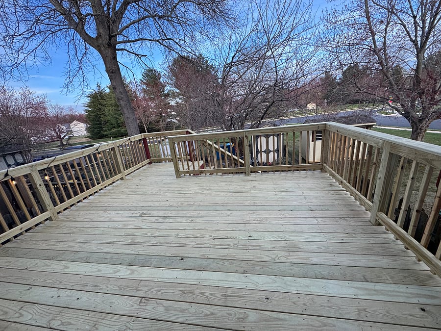 New deck! Decor has been added back in the space and will be pictured soone. A glass table, four chairs, rug, umbrella, and lights along the railing.