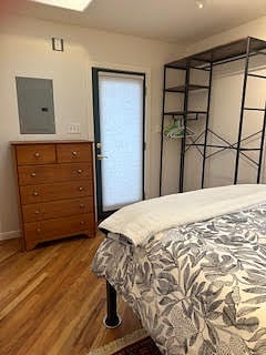 Bedroom with dresser and hanging clothes storage