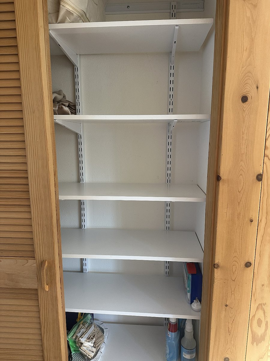 Pantry and linen stored on other side of sliding door.