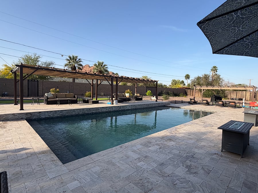 Play pool with large stairs, three waterfall features, and a Baja Shelf. There is also a volleyball net stand for playing in the pool.