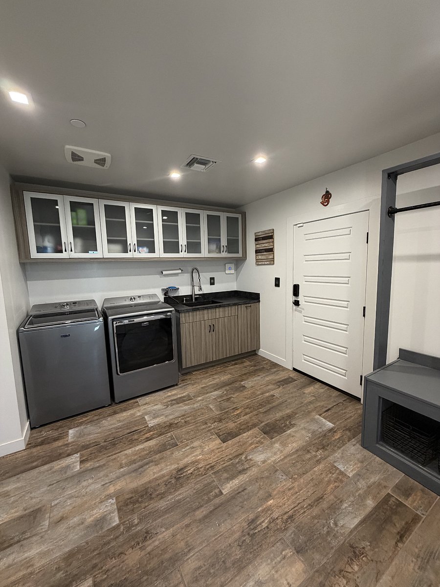 Laundry room with Full Size front loading washer and dryer and exterior door to the garage.